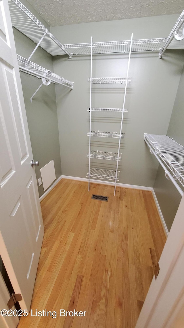 4318 Juniper Forest Pl, Louisville, KY 40245 - walk in closet featuring wood finished floors