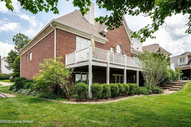 15018 Forest Oaks Dr, Louisville, KY 40245 - rear view of property featuring brick siding, a yard, a chimney, a deck, and a shingled roof