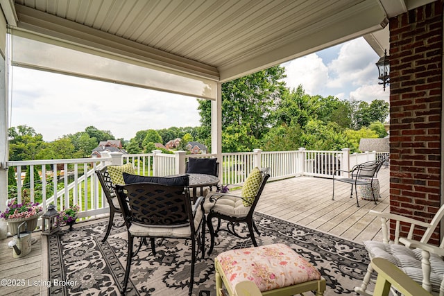 15018 Forest Oaks Dr, Louisville, KY 40245 - wooden deck featuring outdoor dining space and view of wooded area