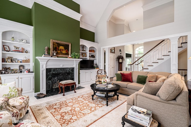 15018 Forest Oaks Dr, Louisville, KY 40245 - living area featuring built in shelves, high vaulted ceiling, stairs, a high end fireplace, and crown molding