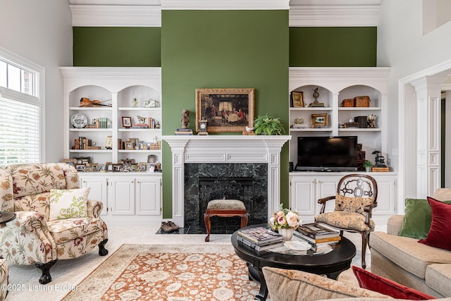 15018 Forest Oaks Dr, Louisville, KY 40245 - carpeted living room featuring crown molding, a high ceiling, a high end fireplace, and decorative columns