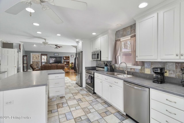 236 Running Creek Dr, Shepherdsville, KY 40165 - kitchen with stainless steel appliances, a ceiling fan, a kitchen island, dark countertops, and tasteful backsplash