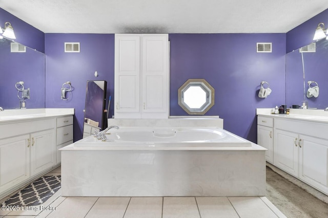 236 Running Creek Dr, Shepherdsville, KY 40165 - full bath featuring a textured ceiling, two vanities, a garden tub, and tile patterned flooring