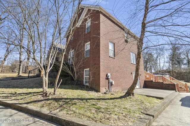 236 Running Creek Dr, Shepherdsville, KY 40165 - view of side of home with brick siding, a yard, and stairway
