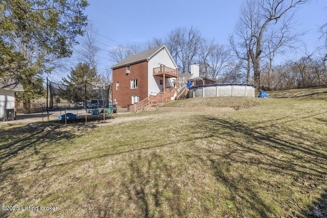 236 Running Creek Dr, Shepherdsville, KY 40165 - view of property exterior with a trampoline, stairs, a wooden deck, and a yard