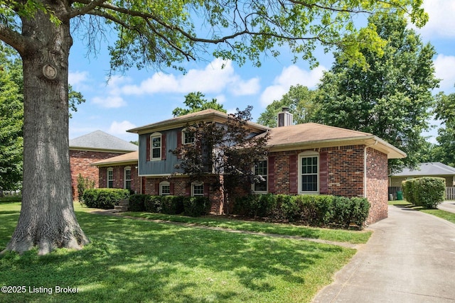 2409 Hayward Rd, Louisville, KY 40242 - split level home with brick siding, a front lawn, and a chimney