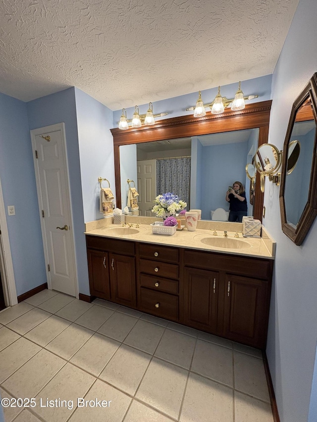 1303 Limestone Trce, Louisville, KY 40223 - bathroom featuring double vanity, tile patterned floors, and a textured ceiling