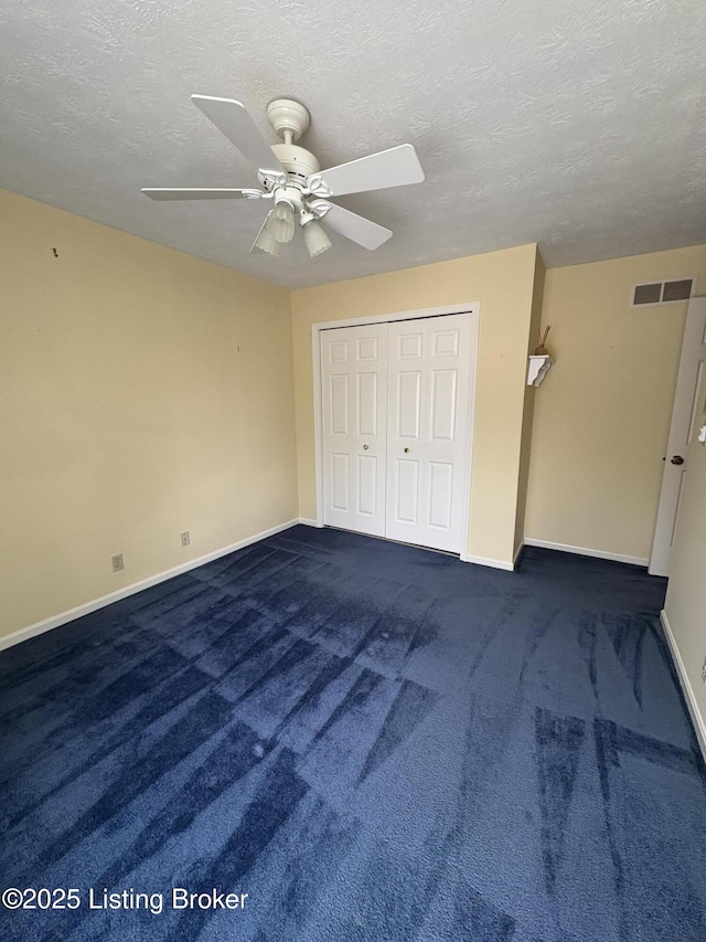 1303 Limestone Trce, Louisville, KY 40223 - unfurnished bedroom featuring dark carpet, a textured ceiling, a closet, and ceiling fan