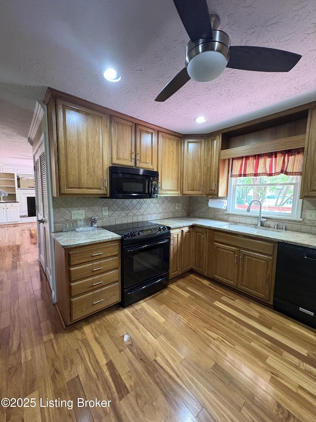 1303 Limestone Trce, Louisville, KY 40223 - kitchen featuring black appliances, a ceiling fan, a textured ceiling, light wood-style floors, and tasteful backsplash