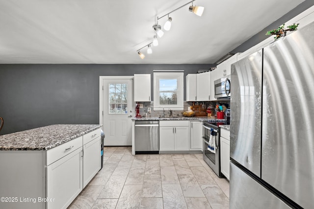 908 Chestnut Ave, Frankfort, KY 40601 - kitchen featuring appliances with stainless steel finishes, white cabinets, stone countertops, tasteful backsplash, and light marble finish floors