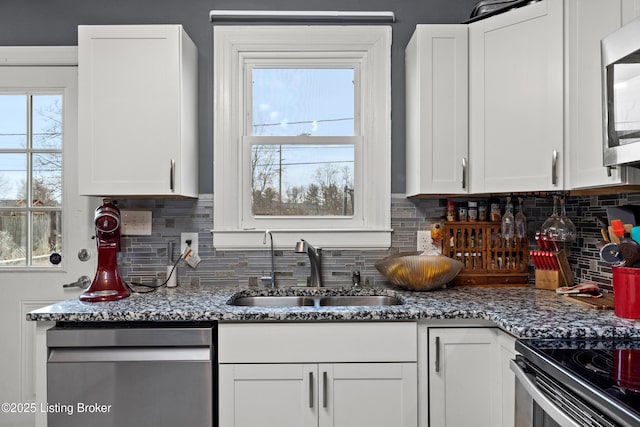 908 Chestnut Ave, Frankfort, KY 40601 - kitchen featuring appliances with stainless steel finishes, white cabinets, tasteful backsplash, and stone counters