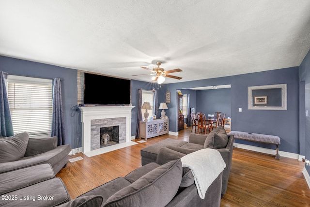 908 Chestnut Ave, Frankfort, KY 40601 - living area featuring a ceiling fan, wood finished floors, a fireplace, and a textured ceiling