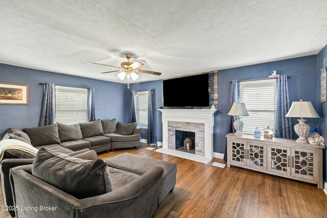 908 Chestnut Ave, Frankfort, KY 40601 - living area featuring wood finished floors, a textured ceiling, a ceiling fan, and a fireplace