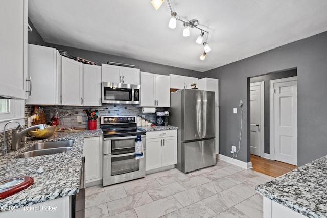 908 Chestnut Ave, Frankfort, KY 40601 - kitchen with stainless steel appliances, backsplash, white cabinetry, light marble finish floors, and light stone counters
