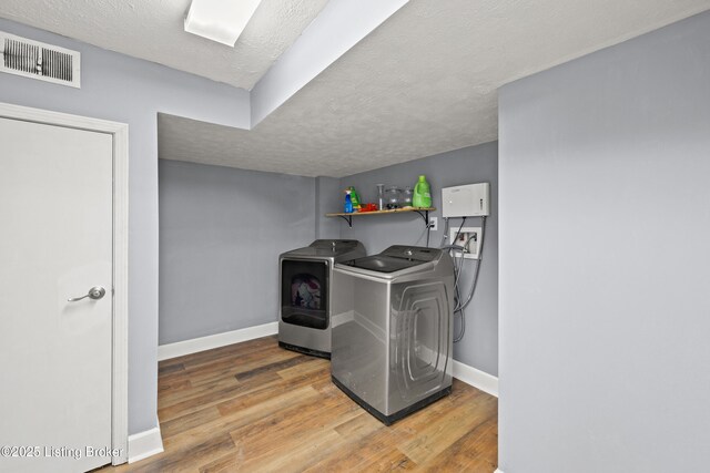 908 Chestnut Ave, Frankfort, KY 40601 - laundry room with wood finished floors, a textured ceiling, and washing machine and clothes dryer