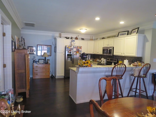 105 Waverly Dr, Bardstown, KY 40004 - kitchen featuring appliances with stainless steel finishes, ornamental molding, a peninsula, white cabinets, and light stone countertops