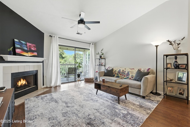 10500 Mcmeekin Ln Unit 208, Louisville, KY 40223 - living area featuring a ceiling fan, a tile fireplace, and wood finished floors