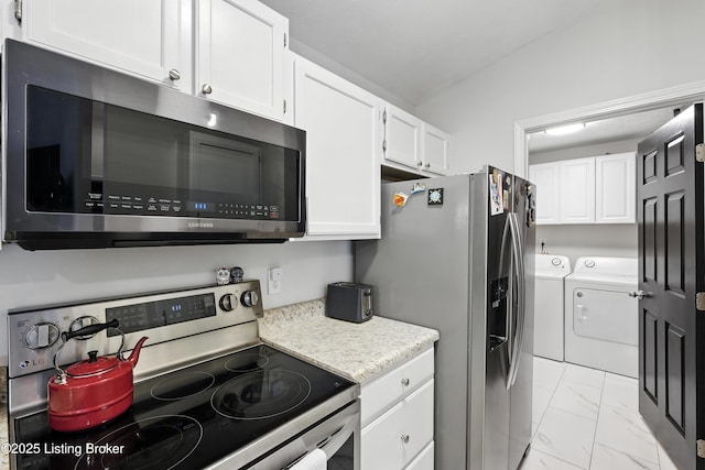 10500 Mcmeekin Ln Unit 208, Louisville, KY 40223 - kitchen with stainless steel appliances, washing machine and dryer, white cabinets, light countertops, and light marble finish floors
