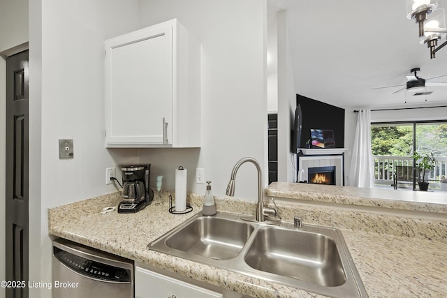 10500 Mcmeekin Ln Unit 208, Louisville, KY 40223 - kitchen featuring dishwasher, white cabinetry, a ceiling fan, and a tile fireplace