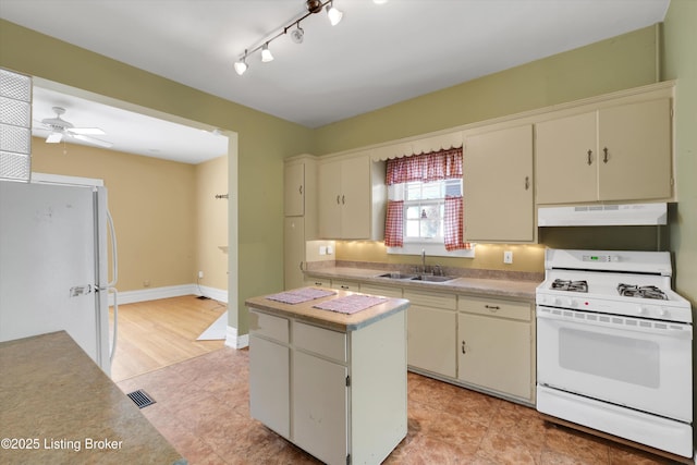 129 N Bellaire Ave, Louisville, KY 40206 - kitchen featuring white appliances, under cabinet range hood, light countertops, a center island, and a ceiling fan