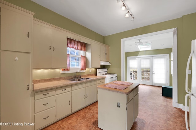 129 N Bellaire Ave, Louisville, KY 40206 - kitchen featuring white appliances, under cabinet range hood, light countertops, and plenty of natural light