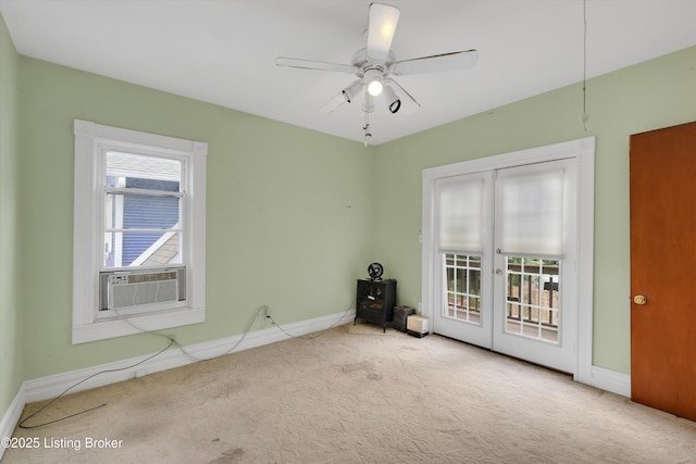 129 N Bellaire Ave, Louisville, KY 40206 - empty room featuring french doors, carpet floors, cooling unit, a wood stove, and a ceiling fan