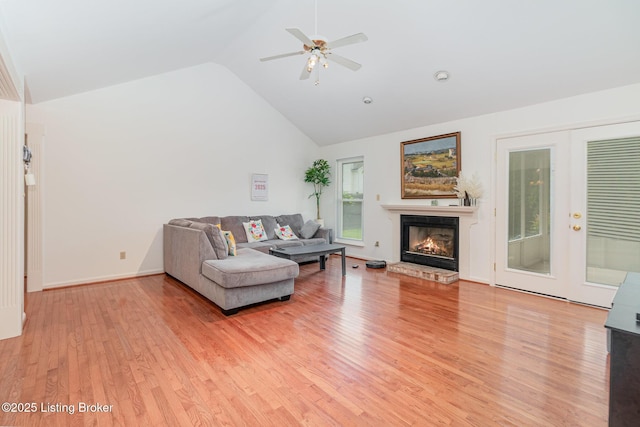 2716 Antone Pkwy, Louisville, KY 40220 - living room with light wood-style flooring, ceiling fan, high vaulted ceiling, and a warm lit fireplace