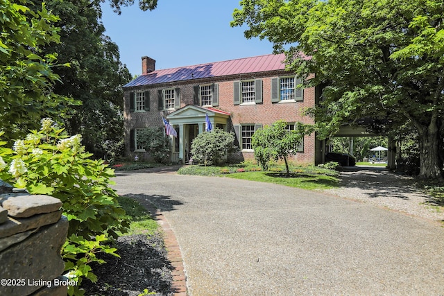 2406 Tucker Station Rd, Louisville, KY 40299 - view of front of property with brick siding, a chimney, a metal roof, asphalt driveway, and a carport