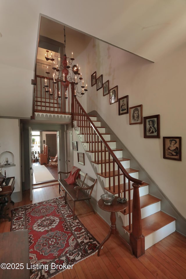 2406 Tucker Station Rd, Louisville, KY 40299 - stairs featuring hardwood / wood-style flooring and a chandelier