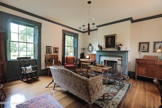 2406 Tucker Station Rd, Louisville, KY 40299 - living area with crown molding, wood finished floors, a chandelier, and a fireplace with flush hearth