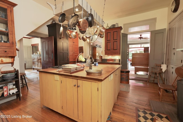 2406 Tucker Station Rd, Louisville, KY 40299 - kitchen with butcher block countertops, light wood-type flooring, ceiling fan, and a center island with sink