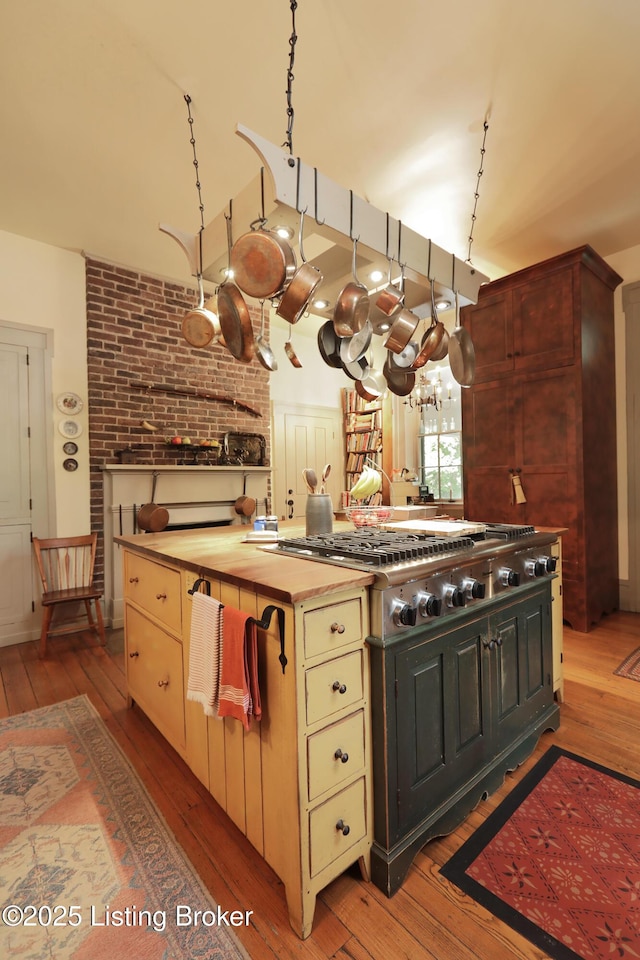 2406 Tucker Station Rd, Louisville, KY 40299 - kitchen featuring light wood-style flooring, stainless steel gas stovetop, and cream cabinets