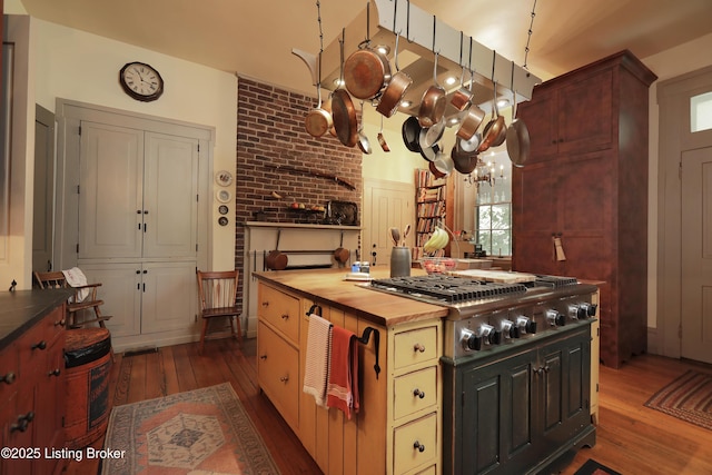 2406 Tucker Station Rd, Louisville, KY 40299 - kitchen featuring wooden counters, dark wood-style floors, stainless steel gas cooktop, and plenty of natural light