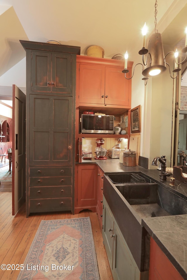 2406 Tucker Station Rd, Louisville, KY 40299 - kitchen featuring light wood-style floors, dark countertops, and pendant lighting