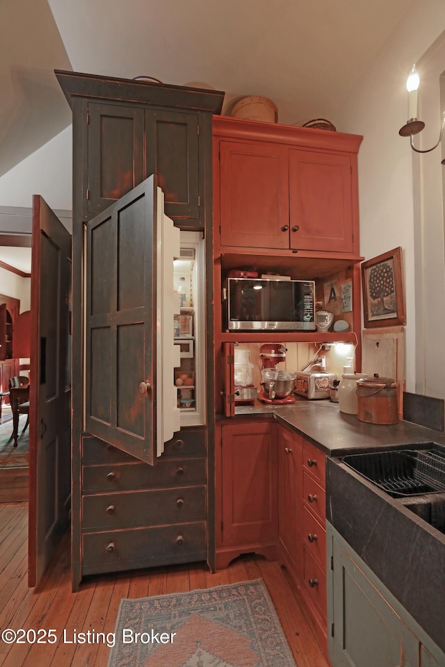 2406 Tucker Station Rd, Louisville, KY 40299 - kitchen with light wood-style floors, dark countertops, and lofted ceiling