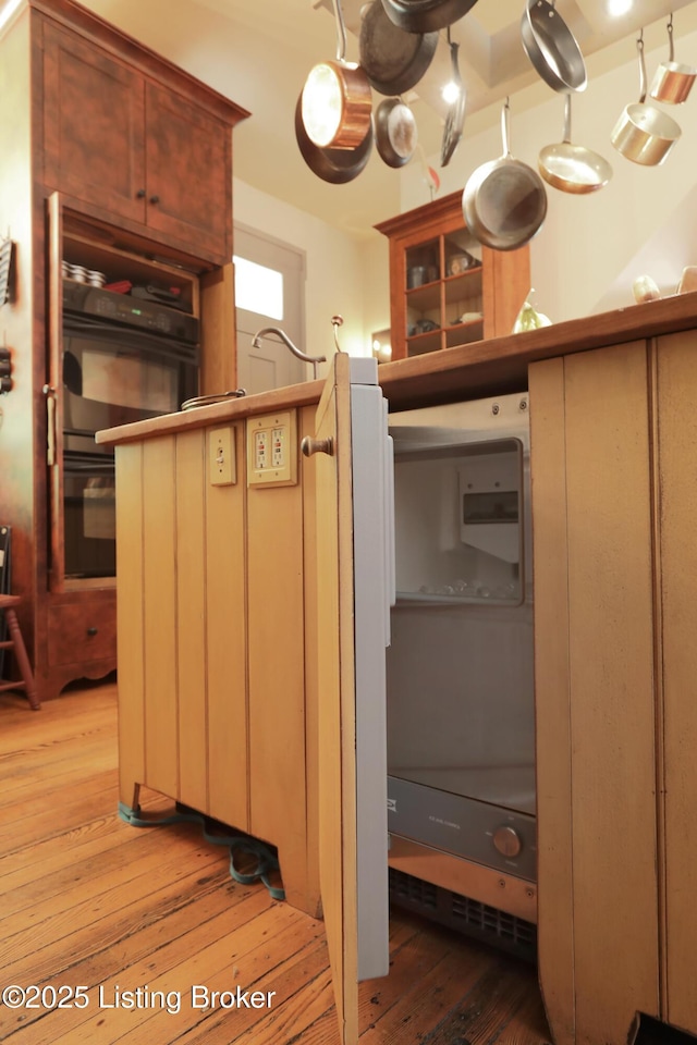 2406 Tucker Station Rd, Louisville, KY 40299 - kitchen with light wood finished floors, glass insert cabinets, and a chandelier