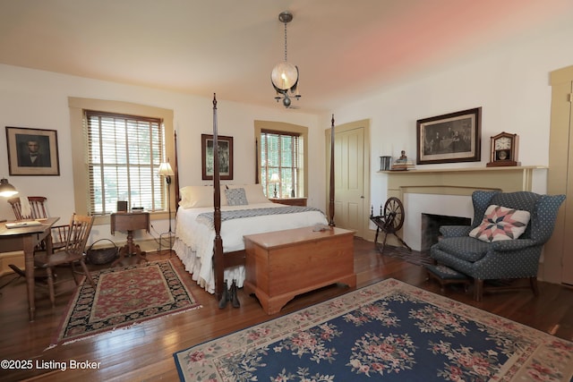 2406 Tucker Station Rd, Louisville, KY 40299 - bedroom with multiple windows, wood finished floors, and a fireplace with flush hearth