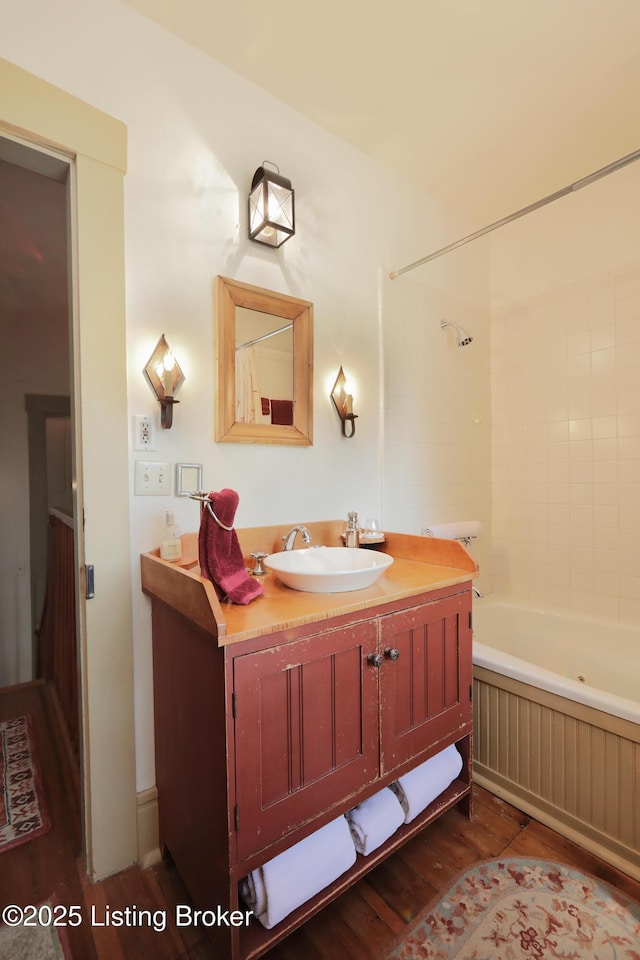2406 Tucker Station Rd, Louisville, KY 40299 - full bathroom featuring wood finished floors, vanity, and shower / tub combination