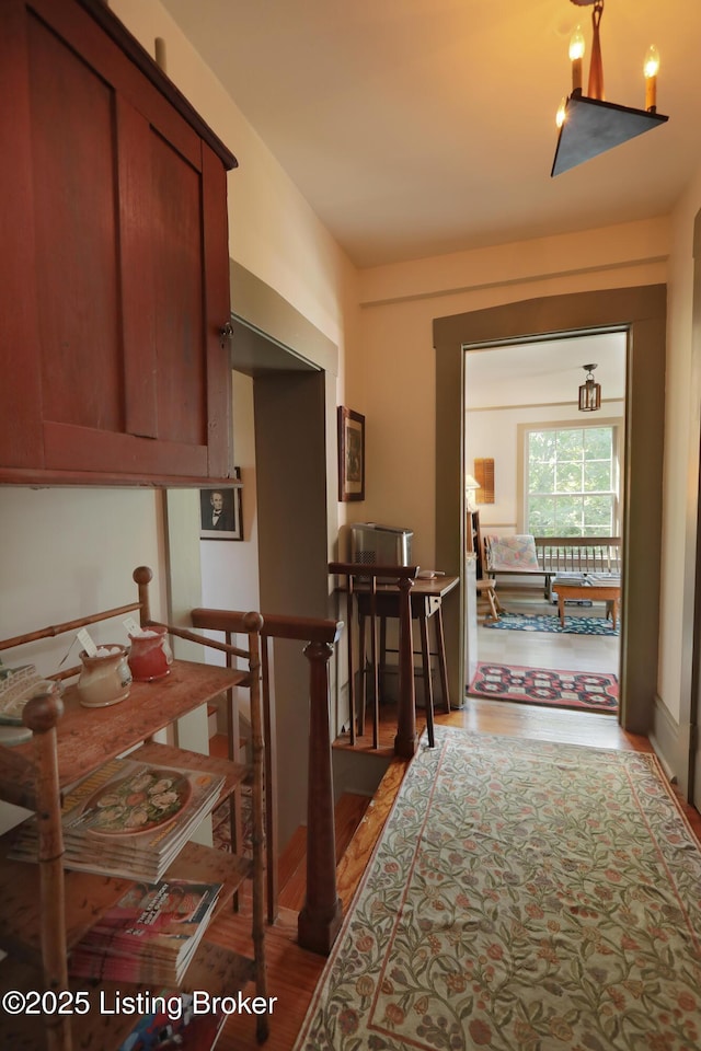 2406 Tucker Station Rd, Louisville, KY 40299 - hallway featuring wood finished floors and an upstairs landing