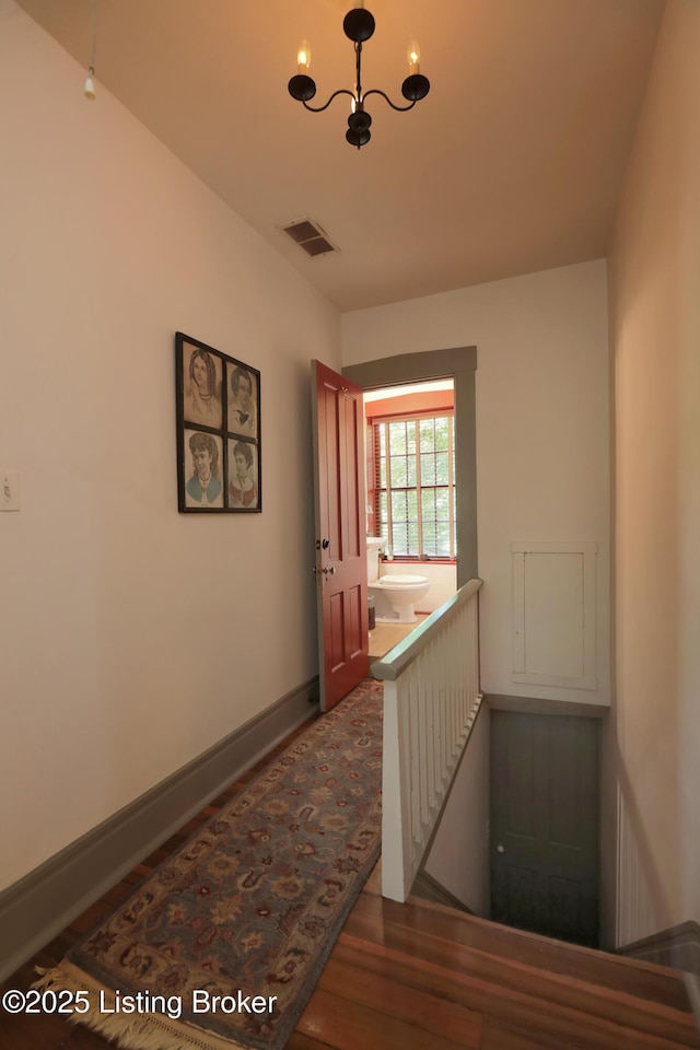 2406 Tucker Station Rd, Louisville, KY 40299 - corridor with an upstairs landing, wood finished floors, and a chandelier