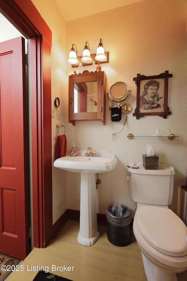 2406 Tucker Station Rd, Louisville, KY 40299 - half bathroom featuring toilet and wood finished floors