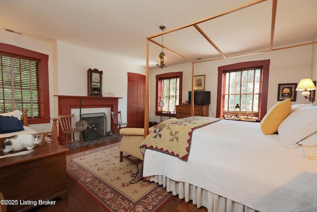 2406 Tucker Station Rd, Louisville, KY 40299 - bedroom with wood finished floors and a fireplace with flush hearth