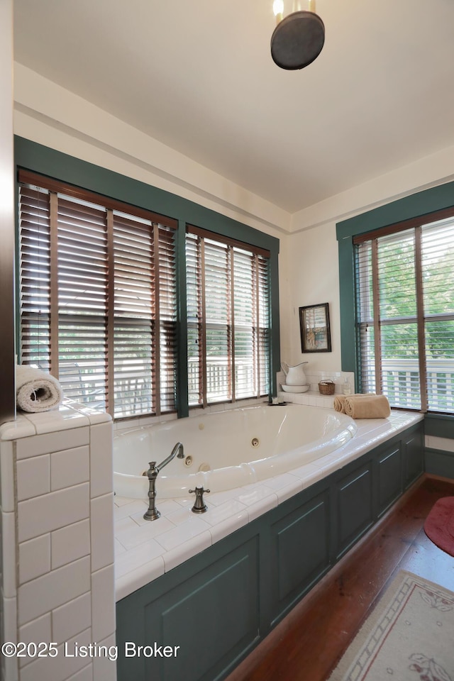 2406 Tucker Station Rd, Louisville, KY 40299 - full bath with healthy amount of natural light, a whirlpool tub, and wood finished floors