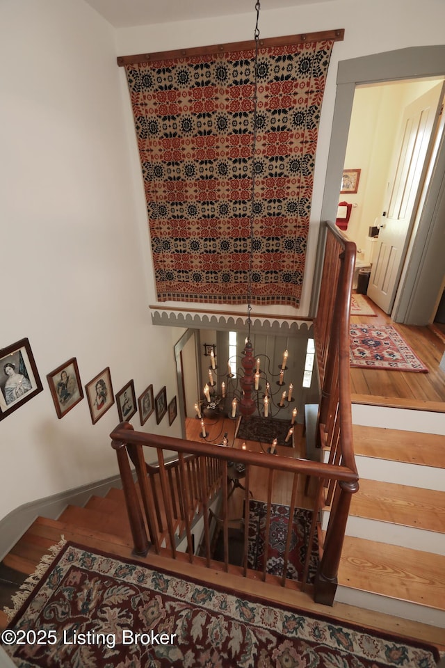 2406 Tucker Station Rd, Louisville, KY 40299 - stairway with a chandelier and wood finished floors