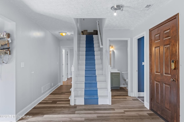 128 Clover Cove Ct, Shepherdsville, KY 40165 - foyer featuring a textured ceiling, stairway, and wood finished floors