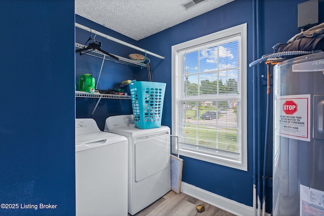 128 Clover Cove Ct, Shepherdsville, KY 40165 - laundry area featuring washing machine and dryer, water heater, wood finished floors, plenty of natural light, and a textured ceiling