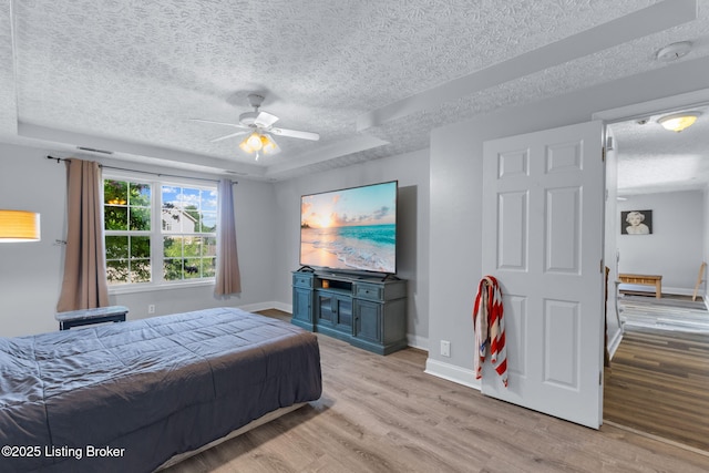 128 Clover Cove Ct, Shepherdsville, KY 40165 - bedroom featuring a textured ceiling, light wood-type flooring, a raised ceiling, and a ceiling fan