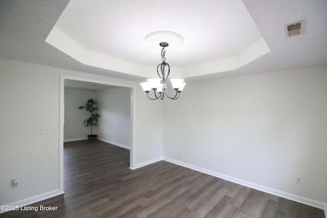 105 Wayne Way, Radcliff, KY 40160 - spare room with a raised ceiling, dark wood-type flooring, and a chandelier