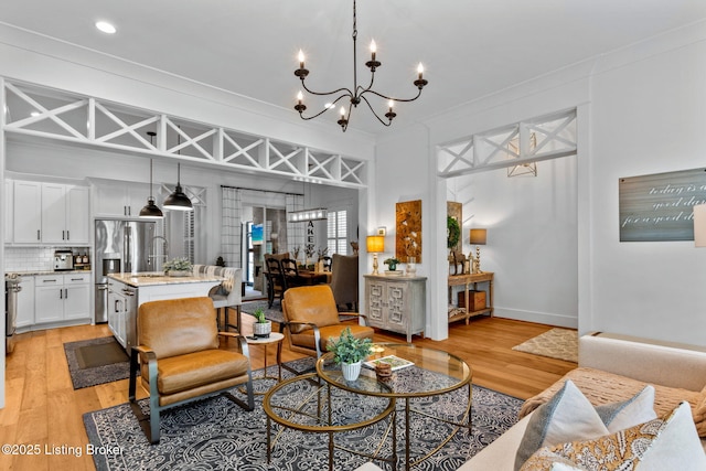 6331 Mistflower Cir, Prospect, KY 40059 - living area with a chandelier, light wood-style floors, and ornamental molding