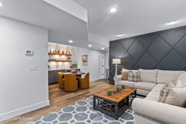 6331 Mistflower Cir, Prospect, KY 40059 - living room with bar with sink, recessed lighting, light wood finished floors, and a decorative wall
